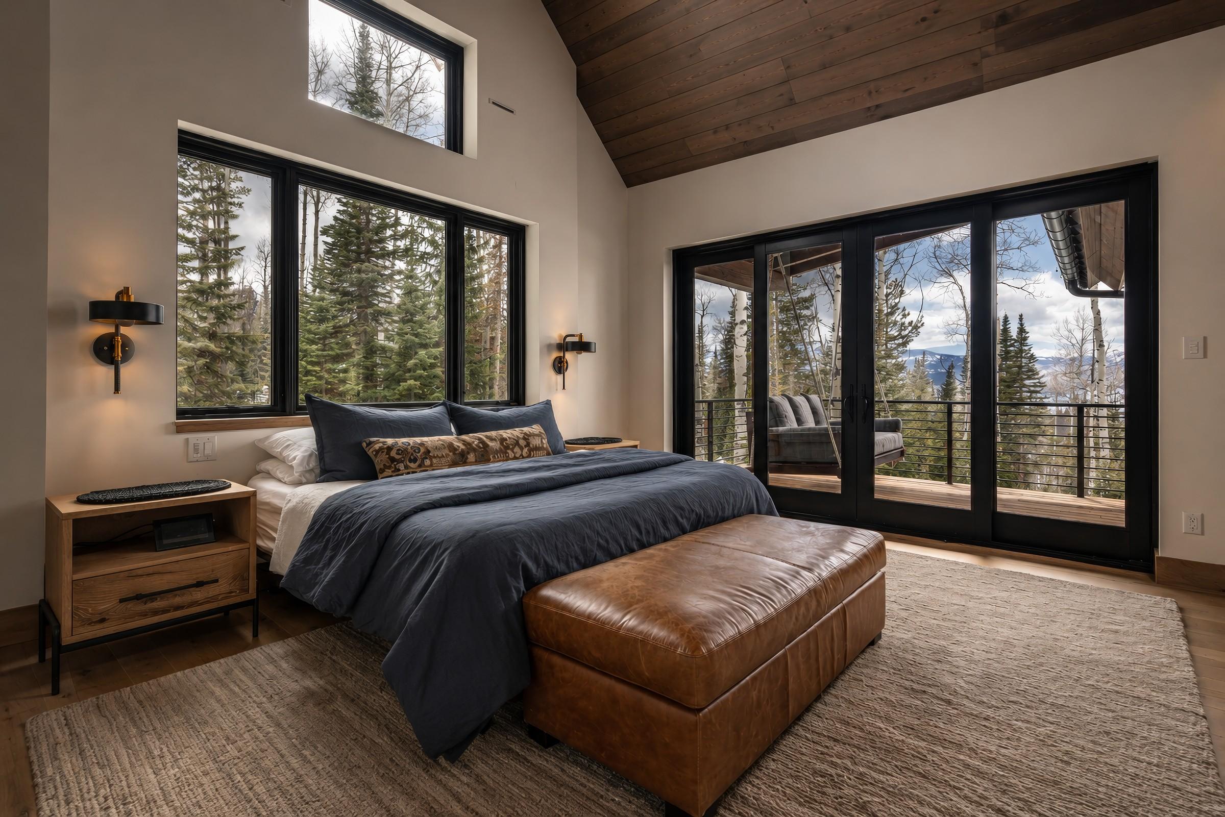 Bedroom with vaulted wood ceiling and mountain view