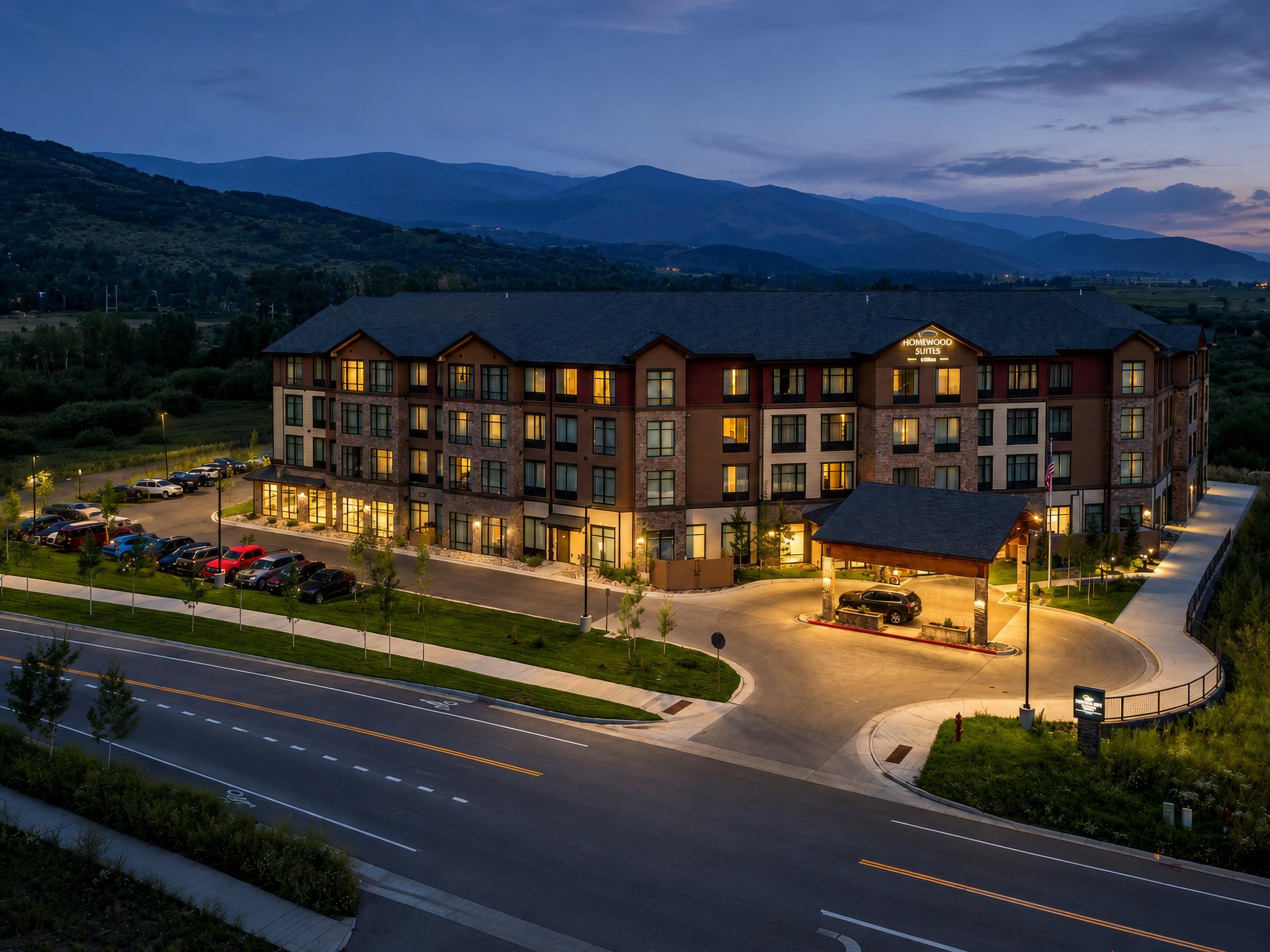 Hotel exterior, aerial view at dusk with mountains beyond