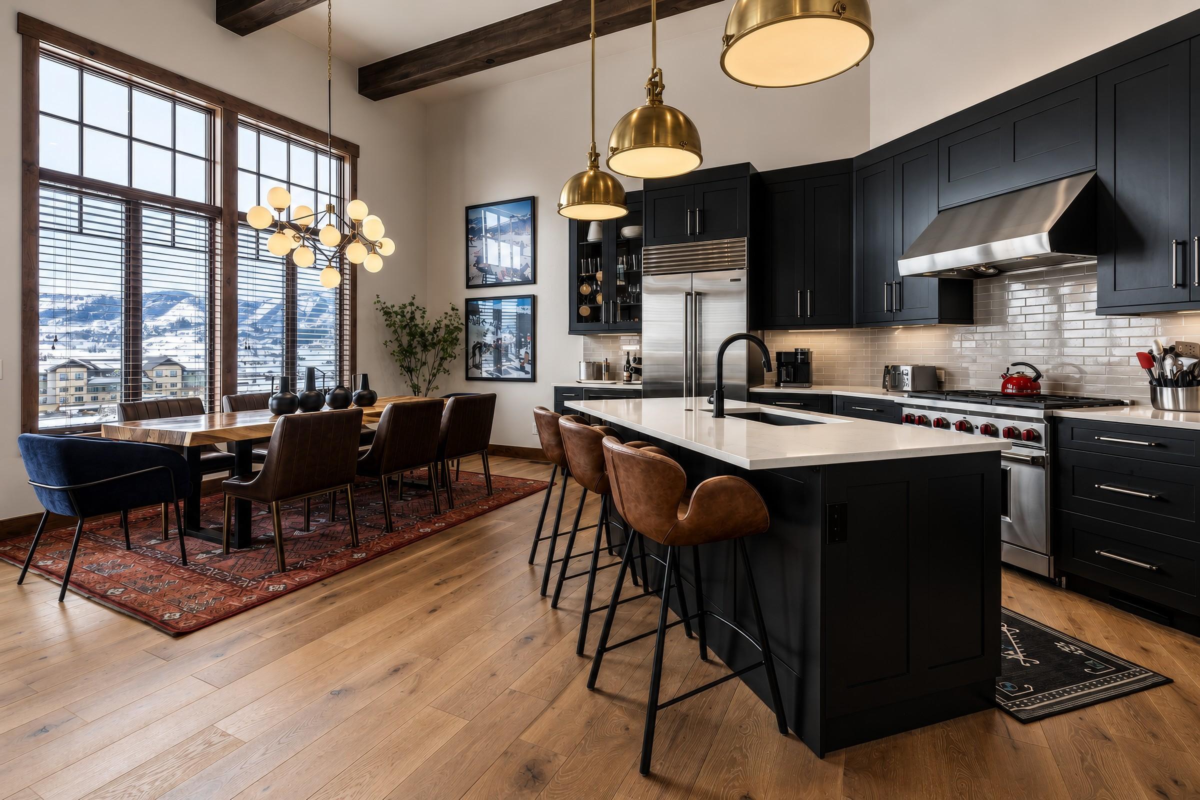 Kitchen island with brass pendant lighting and mountain view