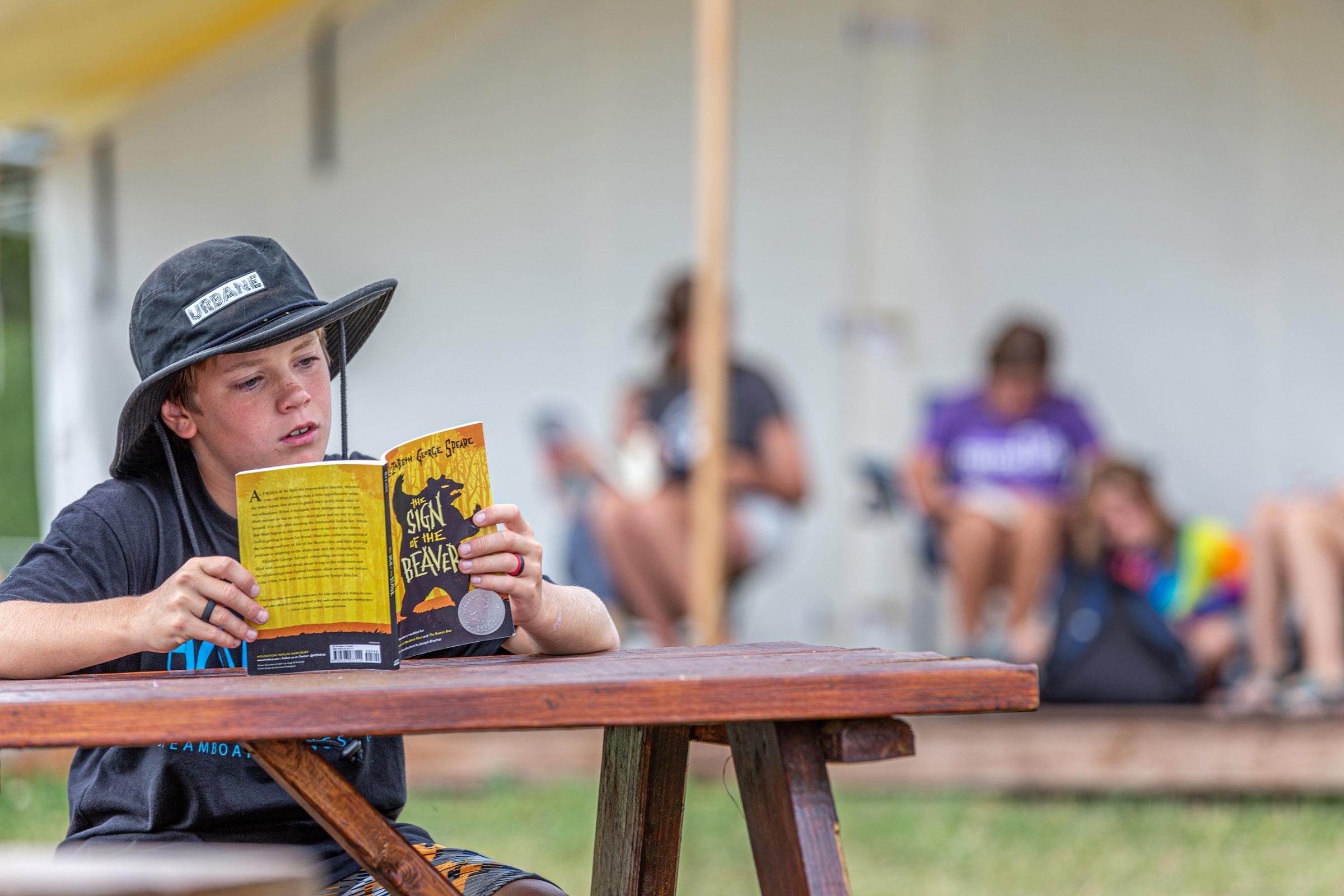Portrait of a camper reading a book
