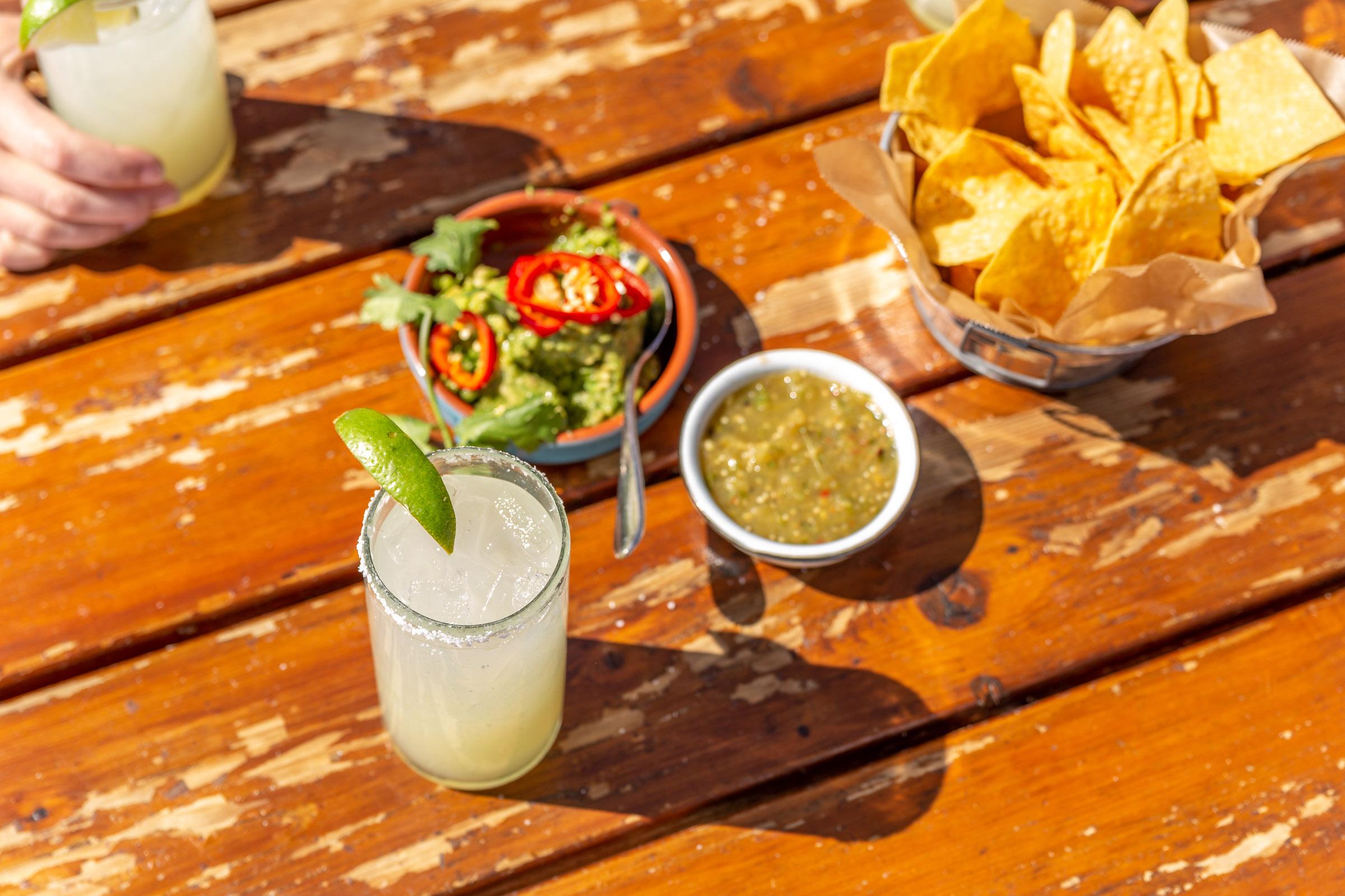 Friends sharing drinks on a rooftop patio during the day