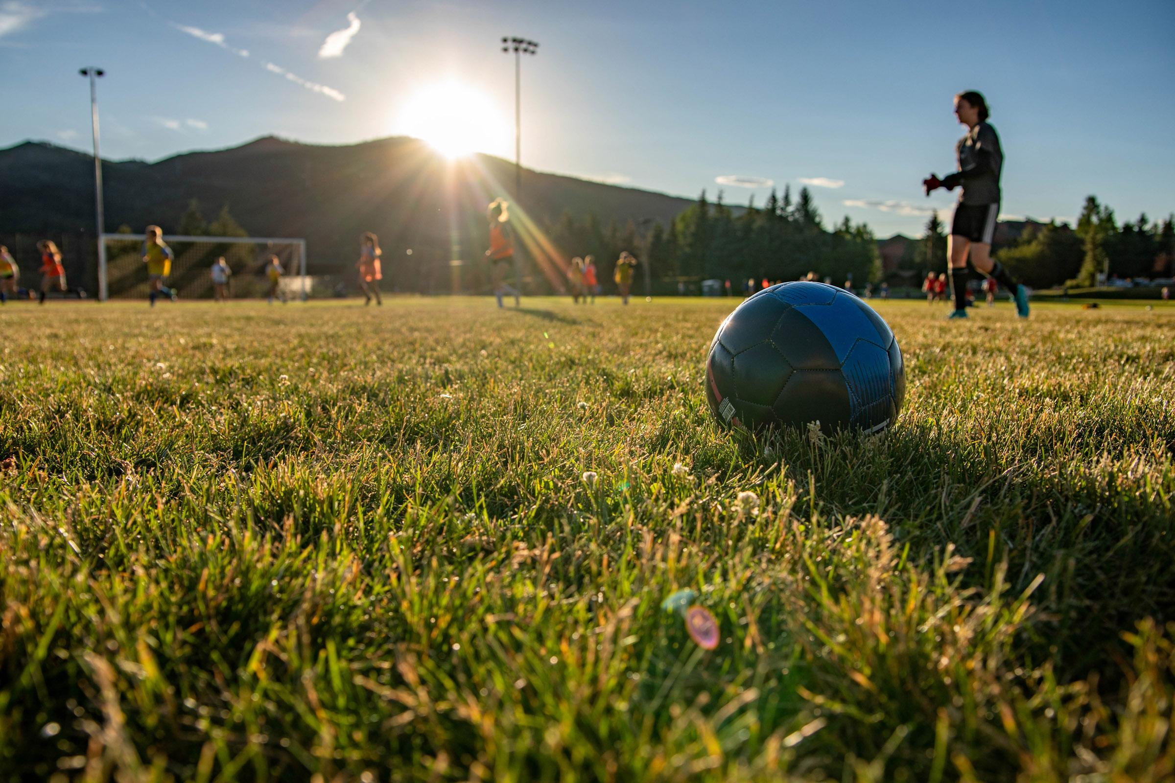 Youth soccer practice at sunset